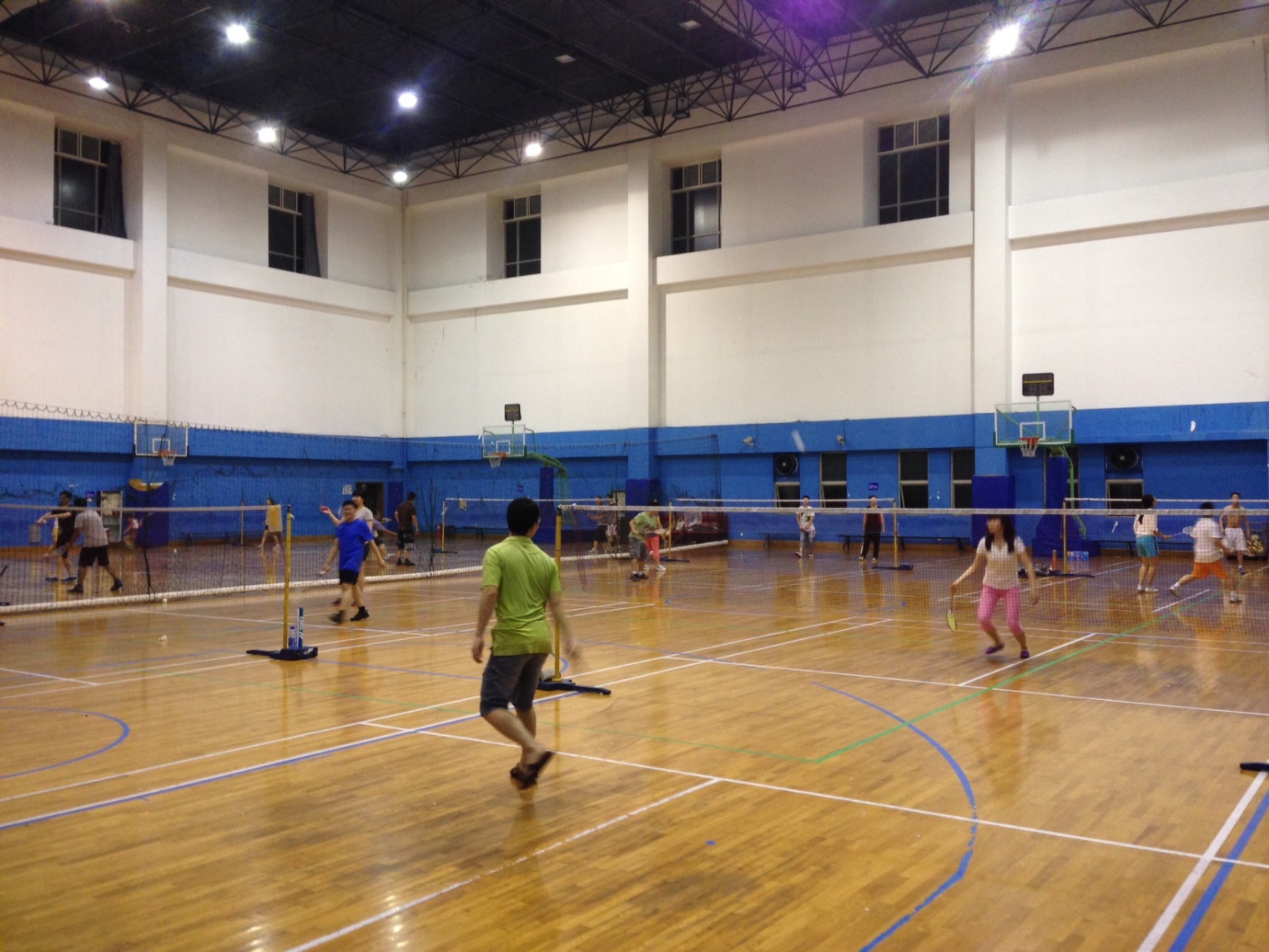 Badminton players in a gym.